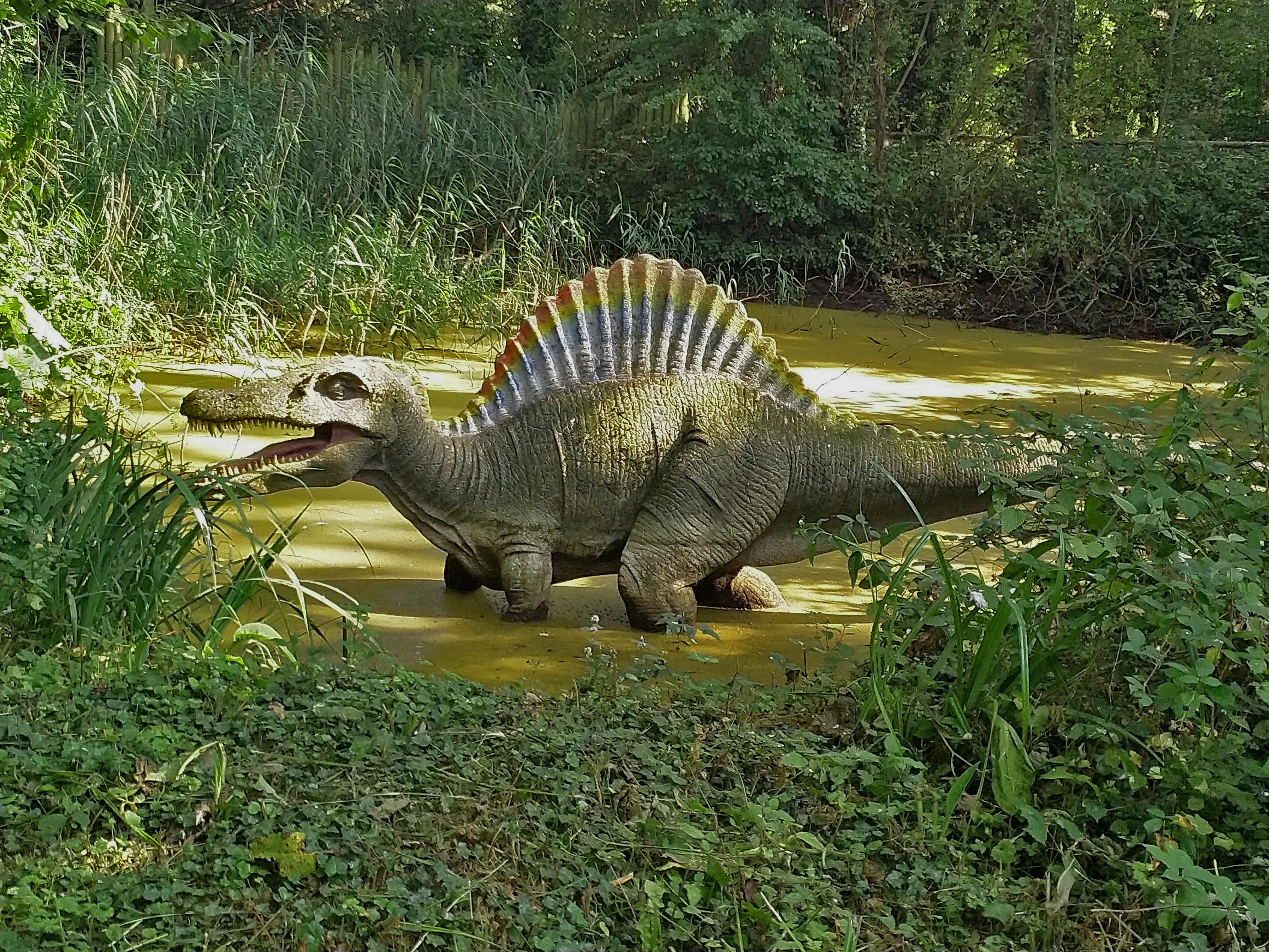 Dinosaur walking through mud